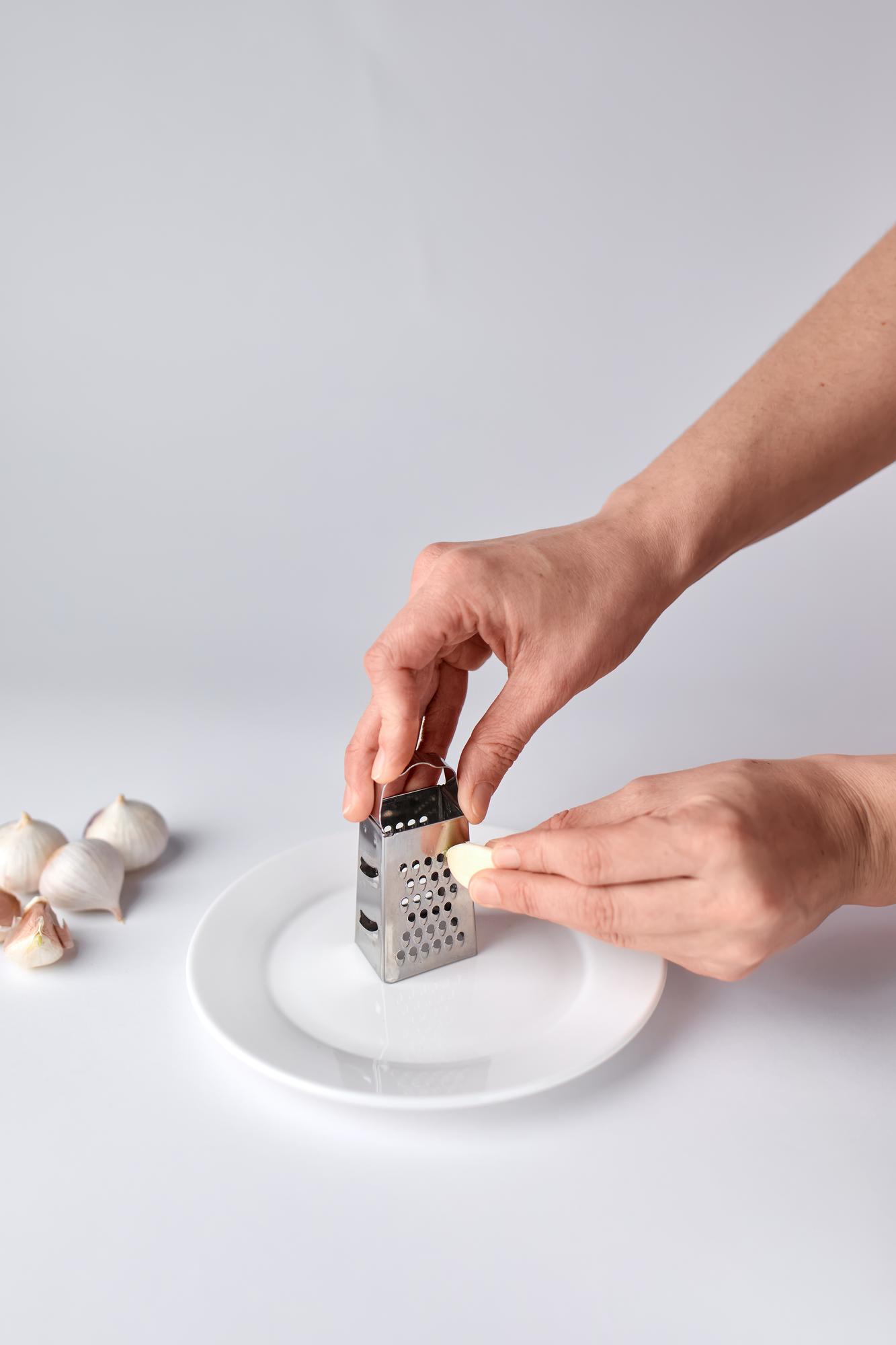 Hands plating dish in workshop